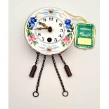An Antique Miniature Keinzle Porcelain Pendulum Wall Clock. 6cm diameter. In original box. In good