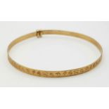 A 9 K yellow gold baby bangle. Weight: 1.7 g.
