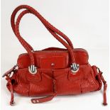 A Chloe Red Shoulder Bag. Red calf leather with silver tone hardware. Two exterior flap pockets with