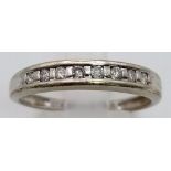 A 9K White Gold Diamond Half-Eternity Ring. Size Q. 2.26g total weight.