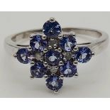 A 9 K white gold ring with iolite and diamonds. Size: P, weight: 3 g.