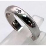 AN 18K WHITE GOLD DIAMOND BAND RING. 5.1gms size K