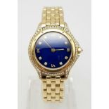 AN 18K GOLD LADIES CARTIER WRISTWATCH WITH DIAMOND BEZEL AND NUMERALS AND STUNNING BLUE FACE AND