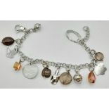 A sterling silver bracelet with smoky quartz and 13 charms. Weight: 24.1 g.