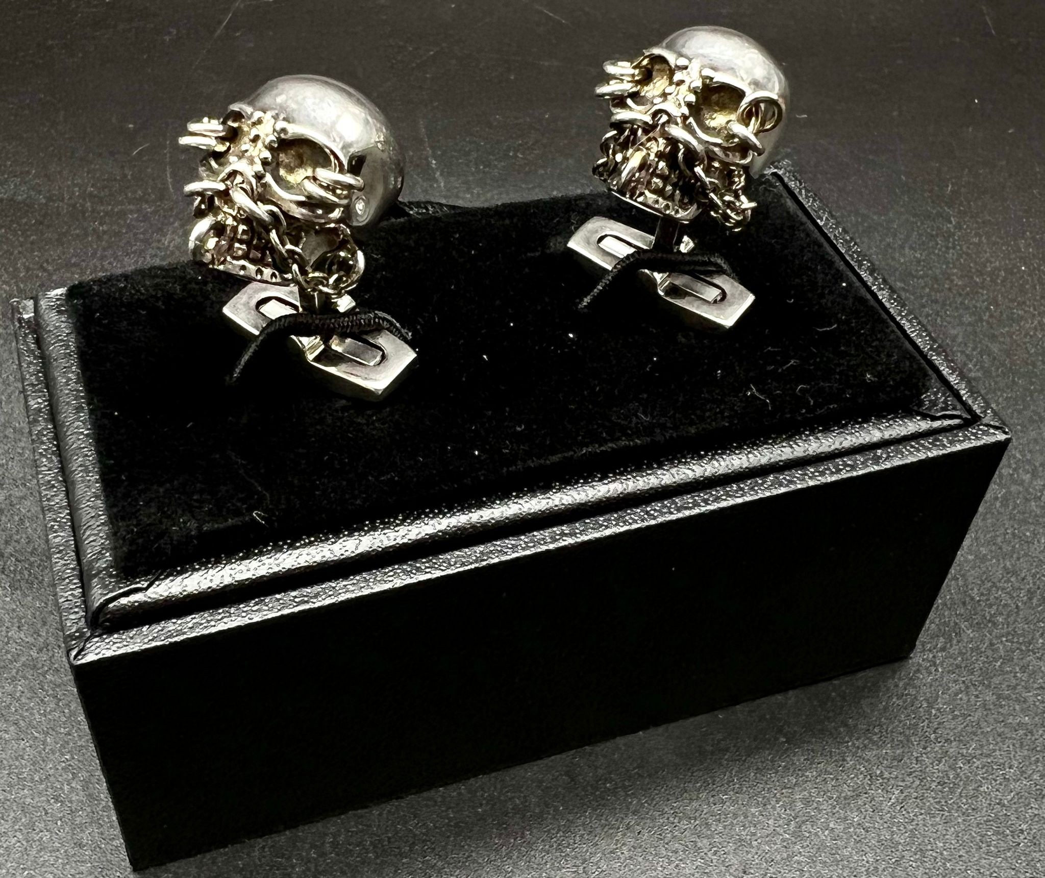 An Iconic ALEXANDER MCQUEEN sculls pair of cufflinks. In excellent condition with original travel