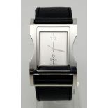 A Stylish Cristian Dior Ladies Watch. Black leather strap with stainless steel case - 30mm width.