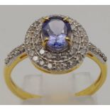 A 1.10cts Tanzanite Gemstone Ring with Two Rows of Diamonds, .45ct set in 14kt Gold. Size N 1/2. 2.