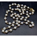 A wire wrapped row of 32 inches cultured pearls.