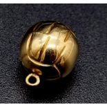 An 9 K yellow gold football charm. Weight: 0.7 g.