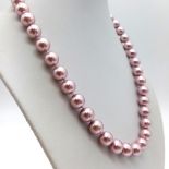 A Lavender 10mm South Sea Shell Pearl Necklace. 42cm. Gilded clasp.