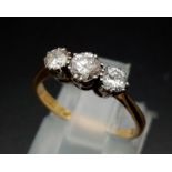 A three stone diamond ring made up of 0.65 carat diamonds set in 18ct yellow gold with a platinum