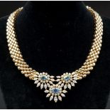 A STUNNING 18K GOLD NECKLACE WITH AQUAMARINE AND DIAMONDS FORMiNG A FLORAL DESIGN . 20.5 gms with