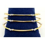 A SET OF 3 DIAMOND SLAVE BANGLES IN 21K GOLD. 17.6gms