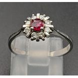 A 9 K white gold ring with a ruby and diamonds cluster. Size: N, weight: 1.8 g.