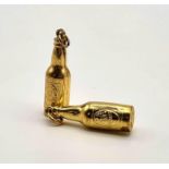 A PAIR OF 18K GOLD GUINESS BOTTLE CHARMS/PENDANTS 2.6gms 3cms