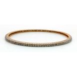 AN 18K GOLD AND DIAMOND SLAVE BANGLE, 11.7gms