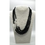 A Graduated Black Onyx and White Porcelain Necklace. A mesmerising blend of onyx beads and jade