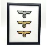 A Framed Set of three WW2 German Cloth Officers Breast Eagles. 28 x 22cm