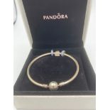 Genuine SILVER PANDORA BANGLE with matching blue sapphire charms together with SILVER CROSS charm.