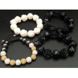 A group of four fancy expandable bracelets