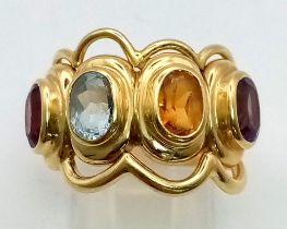 AN 18K YELLOW GOLD DRESS RING WITH 4 DIFFERENT SEMI-PRECIOUS STONES . 12gms size P