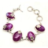 A sterling silver bracelet with magenta coloured banded agate cabochons. In a presentation box.