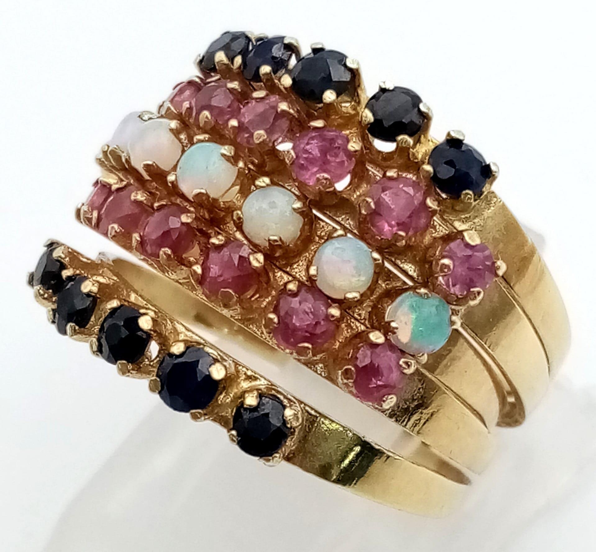 A very unusual 14 K yellow gold five band hinged ring with opals, rubies and sapphires. Ring size: