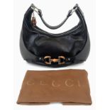 A Gucci Amalfi Full Black Leather Bamboo Handbag. Gold tone hardware. Bamboo clasp and handle. Cloth