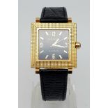AN 18K GOLD BOUCHERON SQUARE WATCH WITH BLACK FACE AUTOMATIC MOVEMENT AND ON A LEATHER STRAP. 28 X