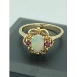 9 carat GOLD RING ring having OPAL and PINK TOPAZ set to top in GOLD openwork mount. 3.3 grams. Size