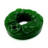 A Green Doughnut Jade Pendant. 3cm diameter.