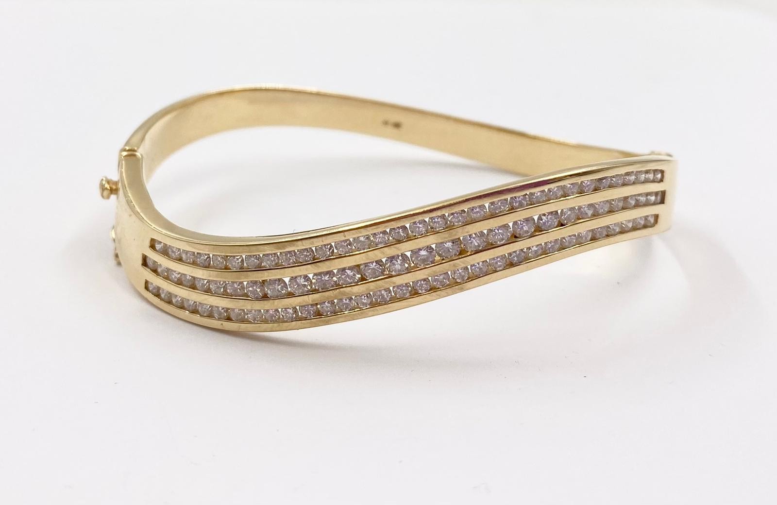 A Stunning 14K Yellow Gold Diamond Twist Bracelet. Over 100 bright round-cut diamonds. (2.5ct