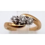 A 9K GOLD 3 DIAMOND RING IN CROSSOVER STYLE. 2.2gms size J