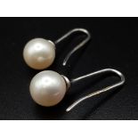 7mm Pearl drop earrings on 18 carat white gold fish hooks very unique and totally classic in design,