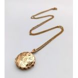 A VINTAGE 9K GOLD LOCKET ON A 60cms CHAIN, NICELY ENGRAVED AND HAVING SCALLOPED EDGING 8.6gms