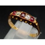 An 18ct yellow gold three rubies and two diamonds ring, size M 1/2, total weight 2.40 grams