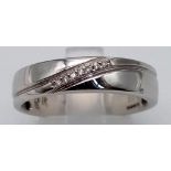 A 9K WHITE GOLD AND DIAMOND BAND RING. 4.8gms size U
