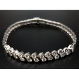 A Beautiful 2.75ct Diamond Bracelet set in 18K White Gold with two figure of eight safety catches.