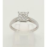 An 9 K white gold diamond (0.20 carats) cluster ring. Size: P, weight: 2 g.
