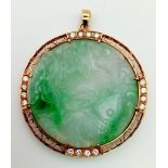 A HAND CARVED JADE MEDALLION IN AN 18K GOLD AND DIAMOND SETTING. 36.5gms 5cms diameter
