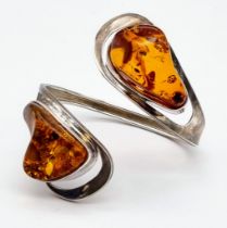 A Baltic Amber Spiral Bangle Bracelet. Two irregular shaped pieces of amber add mystique to this