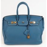 A Hermes Birkin 35 Blue Handbag. Gold tone hardware. Zip and flap pocket interior. 34 x 27cm. In