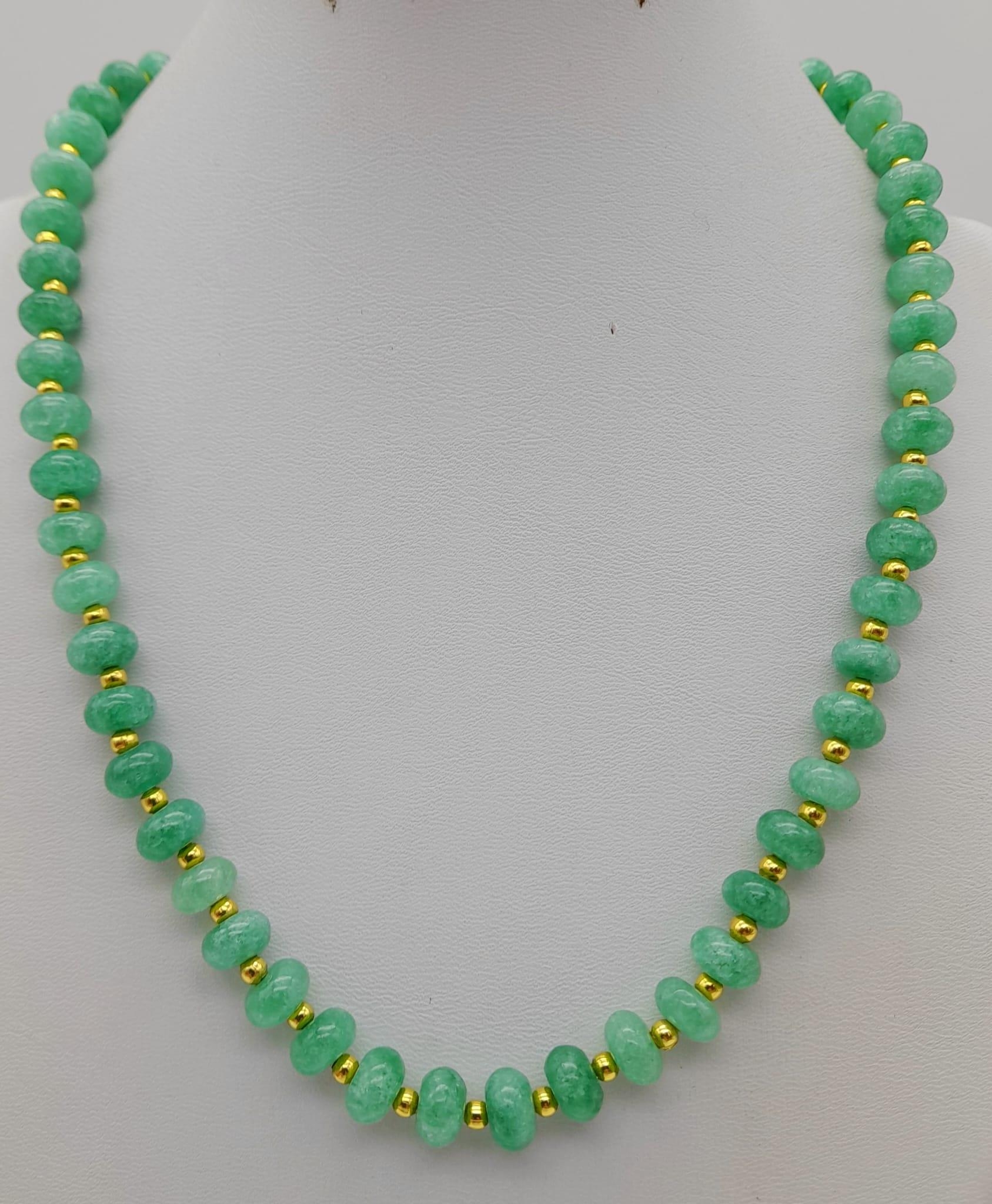 An Emerald Bead Necklace. Gilded spacers and clasp. 44cm.