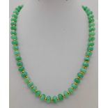 An Emerald Bead Necklace. Gilded spacers and clasp. 44cm.