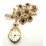 A Rare 1940s 9K Gold Rotary Watch Brooch Pin. A gold bunch of rustic flowers with garnets as