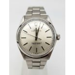 A ROLEX OYSTER PERPETUAL IN STAINLESS STEEL WITH COMPLIMENTARY SILVER TONE DIAL , VERY NICE