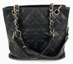 A Chanel Petite Black Leather Shopping Tote Bag. Gilded and leather strap. Flap and zip pocket