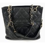 A Chanel Petite Black Leather Shopping Tote Bag. Gilded and leather strap. Flap and zip pocket