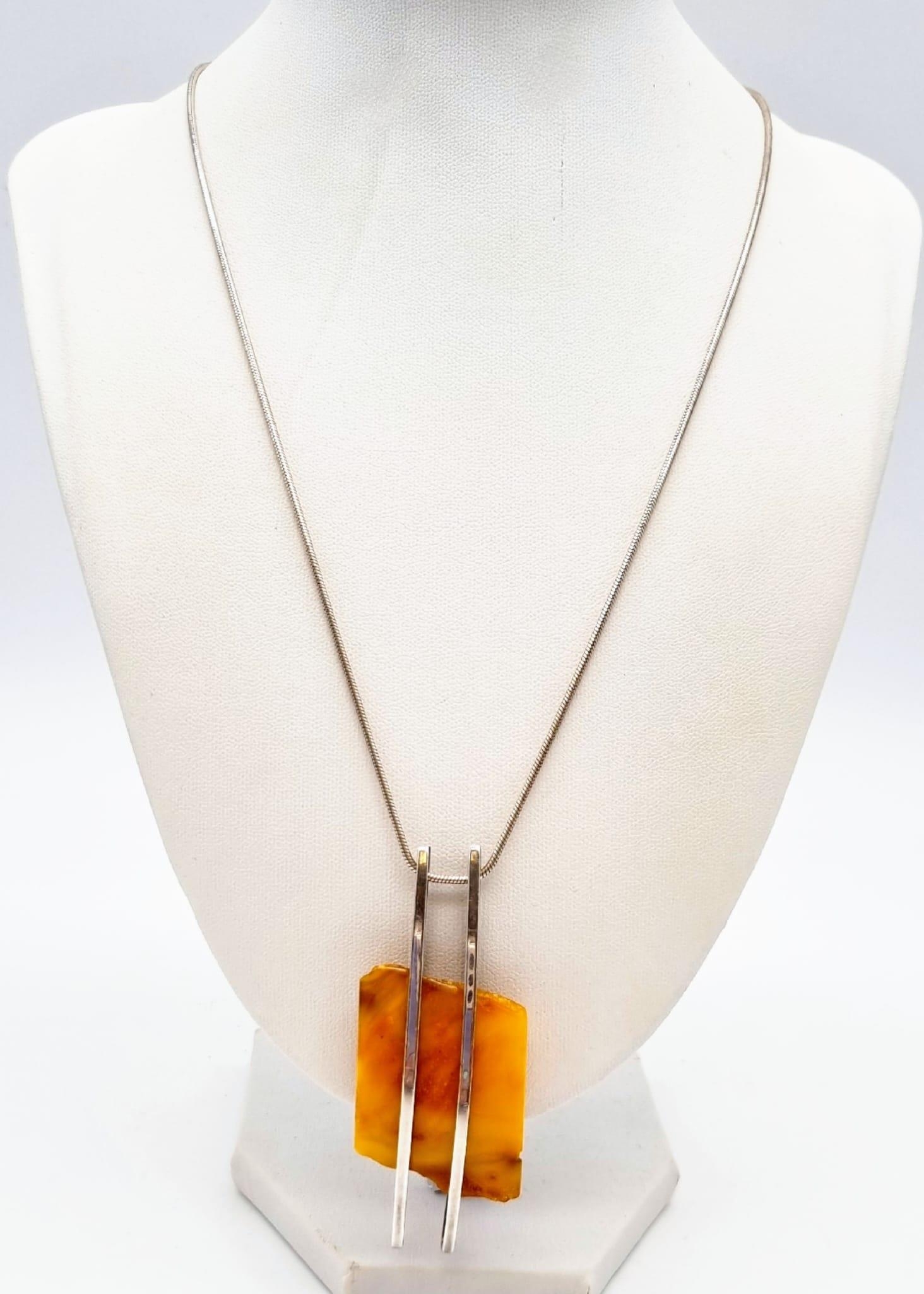 A Honey Amber Pendant Chunk on a 925 Silver Necklace. Amber 3 x 4.5cm. Necklace - 48cm.