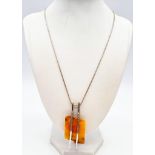 A Honey Amber Pendant Chunk on a 925 Silver Necklace. Amber 3 x 4.5cm. Necklace - 48cm.